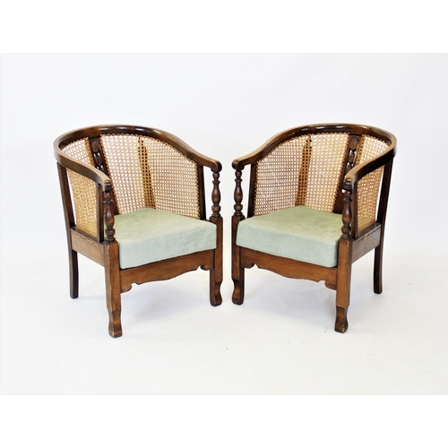 722 - A pair of early 20th century stained beech wood rattan tub chairs, the horse shoe shaped top rail, a... 