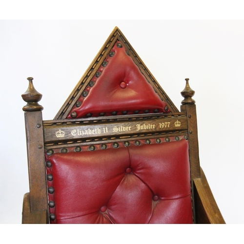 732 - A Queen Elizabeth II Silver Jubilee 1977 carved oak and red leather throne chair, modelled on the co... 