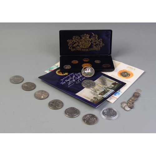 88 - A selection of coins to include an enamelled 1887 crown brooch, twenty six pre-1944 threepences, a R... 