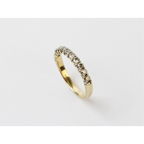 128 - A diamond half eternity ring, comprising eleven small round brilliant cut diamonds claw set in yello... 