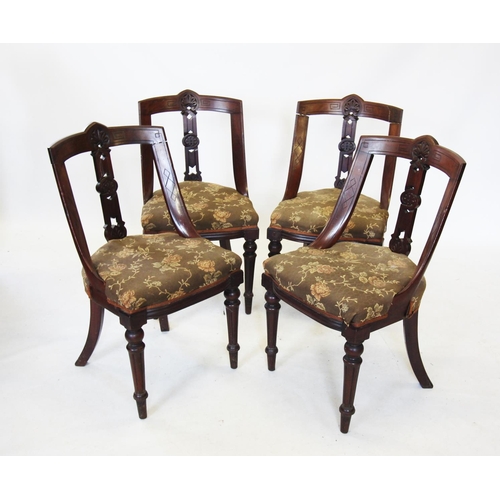 690 - A set of four late Victorian walnut dining chairs, each with a concave rail back above a stuff over ... 