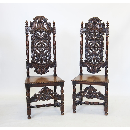 692 - A pair of 17th century style oak hall chairs, late 19th century, each with a carved scrolling foliat... 