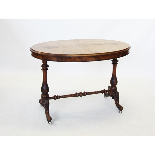 693 - A Victorian burr walnut oval occasional table, the quarter veneered moulded oval top raised upon twi... 