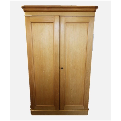 682 - A Victorian pine double wardrobe, with a cavetto cornice above a pair of panelled doors, the left ha... 