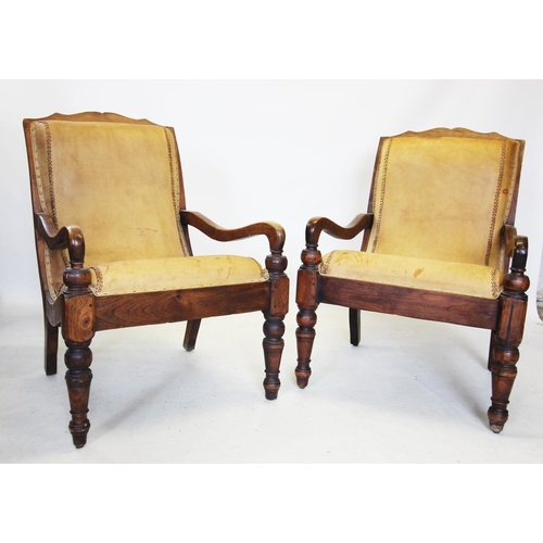 708 - A pair of 19th century style hardwood plantation chairs, the tan leather padded backs extending to d... 