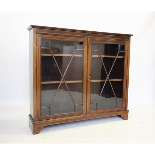 728 - An Edwardian mahogany display cabinet by Maple & Co, London, the rectangular cross banded top above ... 