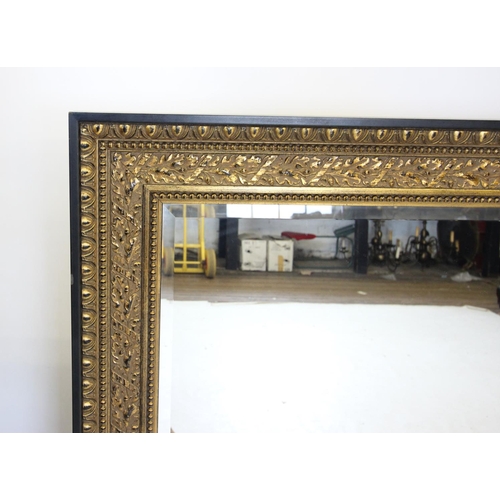 739 - A large gilt framed rectangular wall mirror, late 20th century, the oak leaf moulded frame enclosing... 