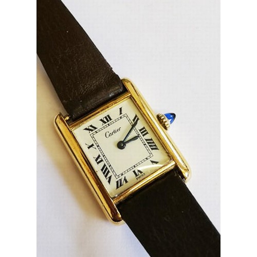 109 - A lady's gold plated Cartier Tank wristwatch, the rectangular cream dial with black Roman numerals, ... 