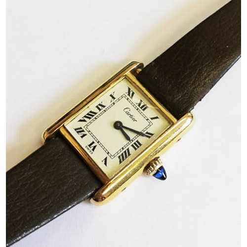 109 - A lady's gold plated Cartier Tank wristwatch, the rectangular cream dial with black Roman numerals, ... 