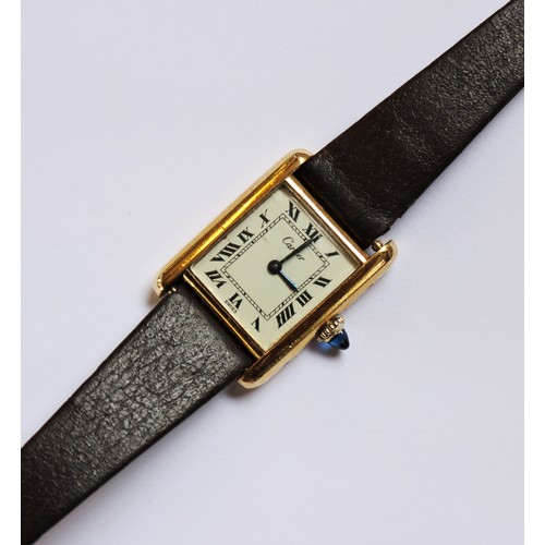 109 - A lady's gold plated Cartier Tank wristwatch, the rectangular cream dial with black Roman numerals, ... 