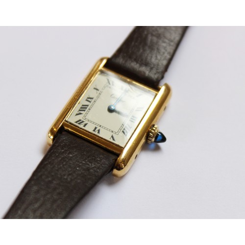 109 - A lady's gold plated Cartier Tank wristwatch, the rectangular cream dial with black Roman numerals, ... 