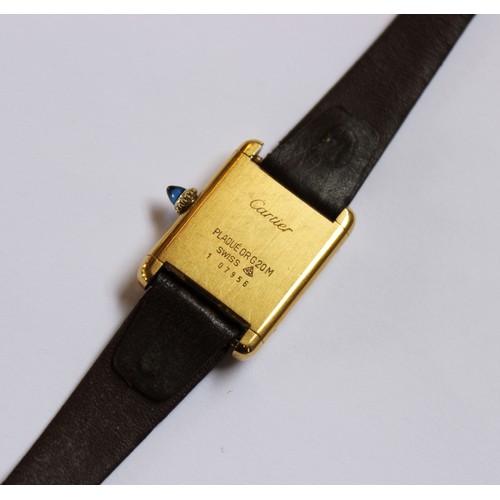 109 - A lady's gold plated Cartier Tank wristwatch, the rectangular cream dial with black Roman numerals, ... 