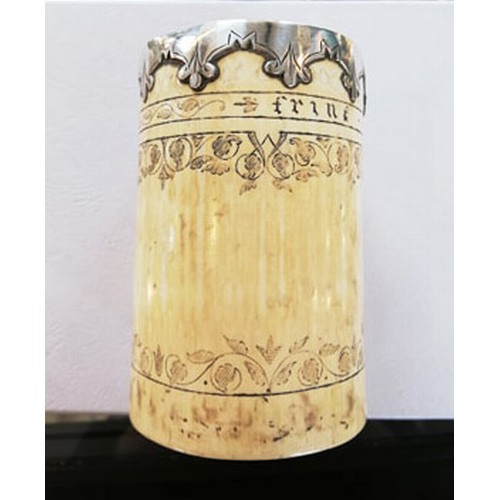 87 - A white metal mounted scrimshaw tusk pot, inscribed 'Frine favfer und fief' below the metal mounted ... 