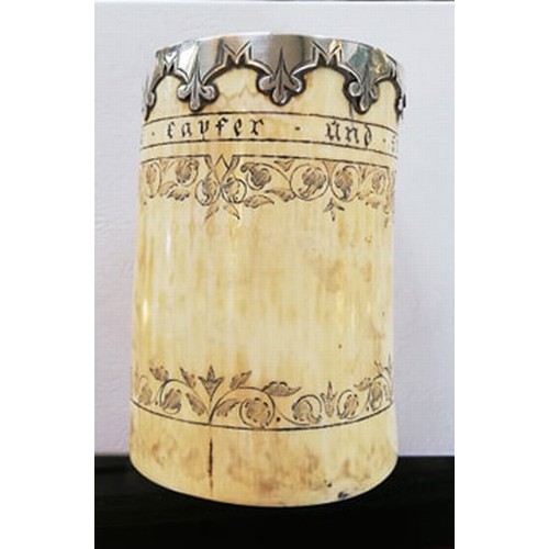 87 - A white metal mounted scrimshaw tusk pot, inscribed 'Frine favfer und fief' below the metal mounted ... 