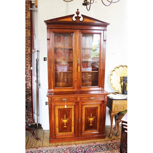 704 - An Edwardian Sheraton revival mahogany library bookcase, the architectural pediment inlaid with sati... 