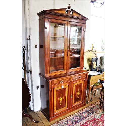 704 - An Edwardian Sheraton revival mahogany library bookcase, the architectural pediment inlaid with sati... 