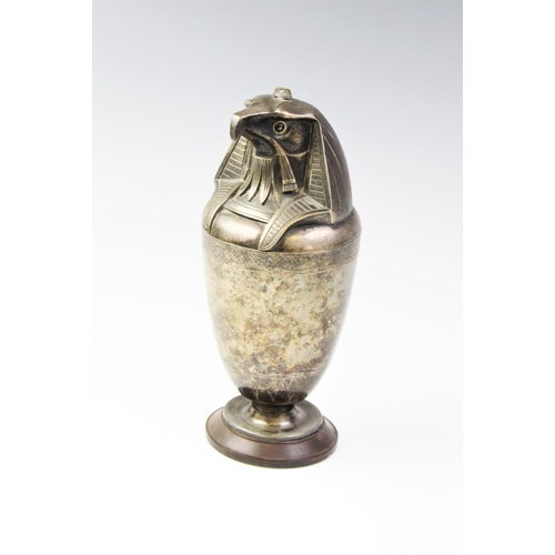 44 - A white metal Egyptian canopic jar horus, modelled as an eagle, 28cm high
