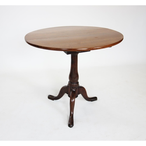 827 - A George III oak tripod table, the circular top upon a bird cage movement and a baluster stem, exten... 