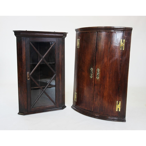 828 - A George III oak bow front hanging corner cupboard, the pair of doors on 'H' brass hinges enclosing ... 