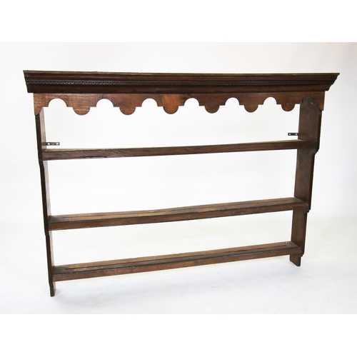 832 - A George III style oak dresser rack, with a moulded dentil cornice above a shaped frieze  and three ... 