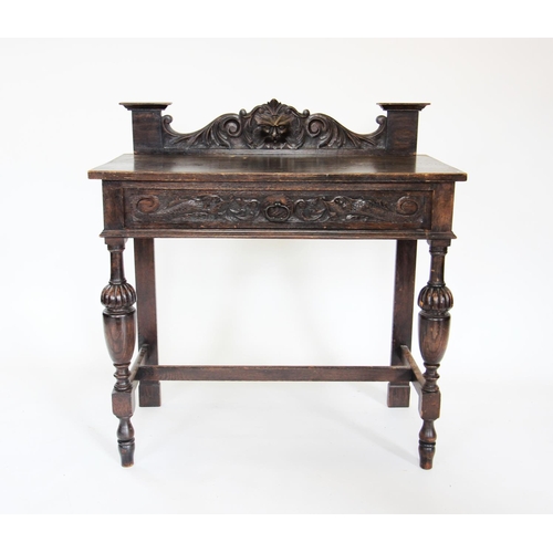 847 - A late Victorian oak green man side table, the galleried back centred with a carved green man mask, ... 