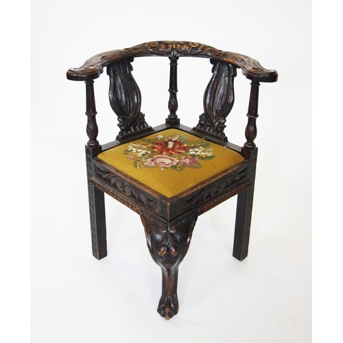 857 - A Victorian carved oak corner chair, the bow shaped top rail centred with a carved green man mask, e... 