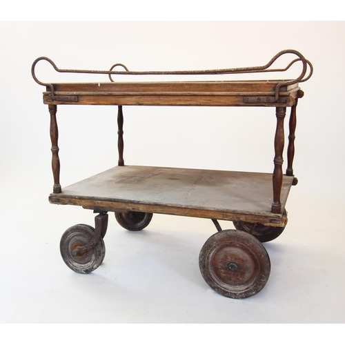 868 - A 19th century two tier serving trolley, the upper tray with iron side rails upon turned supports un... 