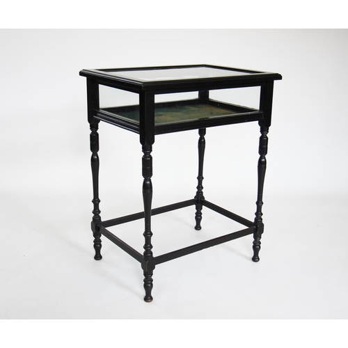 875 - An Edwardian ebonised bijouterie table, the rectangular hinged cabinet raised upon slender turned le... 