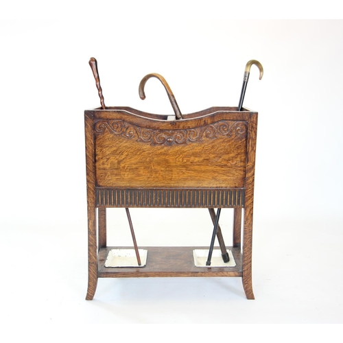 880 - An early 20th century oak stick stand, with twin compartments over a pair of inset metal trays, 72cm... 