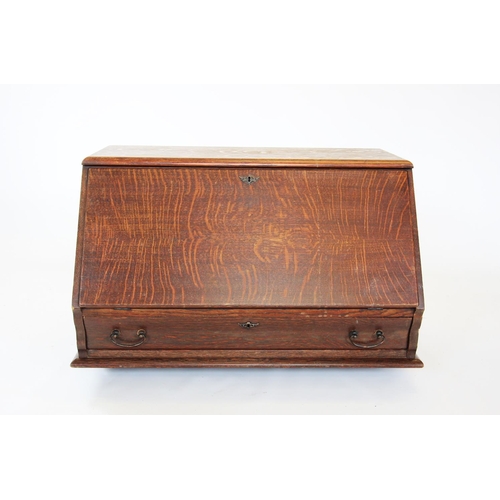 886 - An early 20th century oak stacking bureau, the fall front enclosing a compartmentalised interior, ab... 