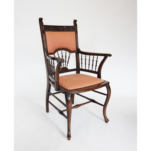 896 - An Edwardian mahogany elbow chair, the carved top rail above a shaped padded back rest and a fan arr... 