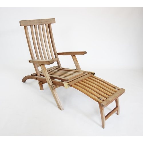 913 - A teak steamer chair, late 20th century, of slatted form with brass fittings and a folding foot rest