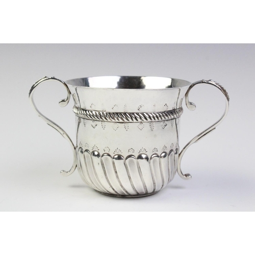 14 - A 17th century style Britannia silver porringer by Harry Freeman, London 1911, of typical form with ... 