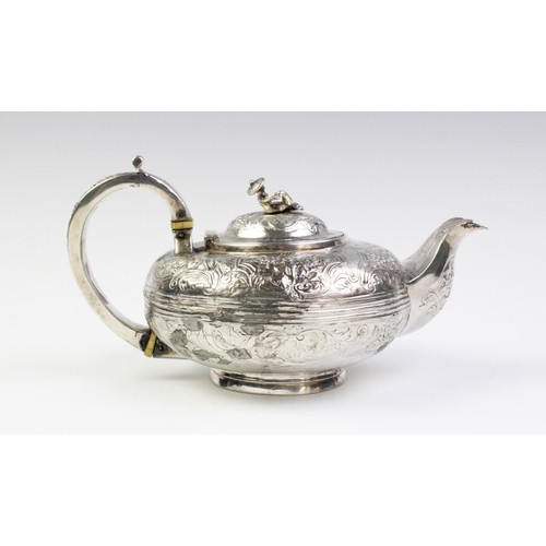 18 - A Victorian white metal teapot, of squashed ovoid form with scroll capped handle on circular spreadi... 
