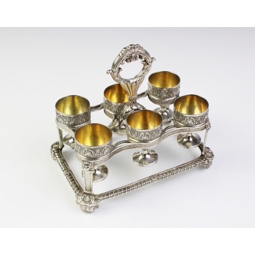 24 - A George III silver egg cruet by Phillip Rundell, London 1819, the rectangular stand with gadrooned ... 