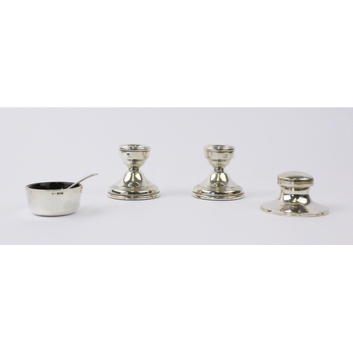 51 - A pair of weighted silver candle holders by W I Broadway & Co, Birmingham 1994, each 5.8cm high, tog... 
