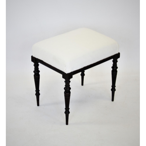 835 - A late 19th century aesthetic movement mahogany foot stool, the rectangular re upholstered top above... 