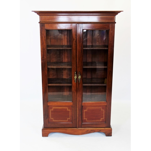 874 - An Edwardian mahogany display cabinet, the moulded cornice above a frieze inlaid with chevron string... 