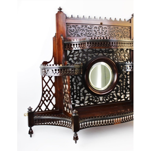 895 - An early 20th century Chinese Chippendale revival mahogany wall shelf, of fretwork form, the central... 