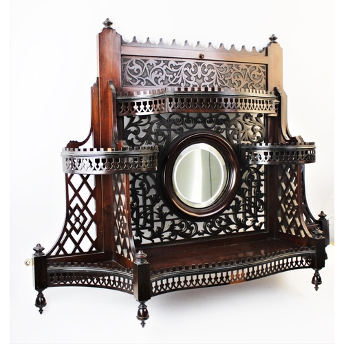 895 - An early 20th century Chinese Chippendale revival mahogany wall shelf, of fretwork form, the central... 