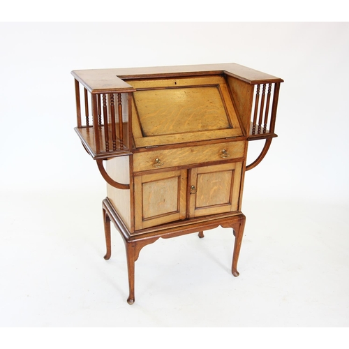 905 - An early 20th century mahogany Arts and Crafts students desk, the angular 'C' shaped top enclosing a... 