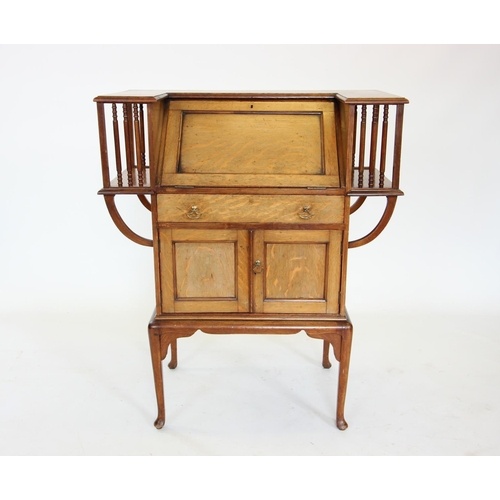 905 - An early 20th century mahogany Arts and Crafts students desk, the angular 'C' shaped top enclosing a... 