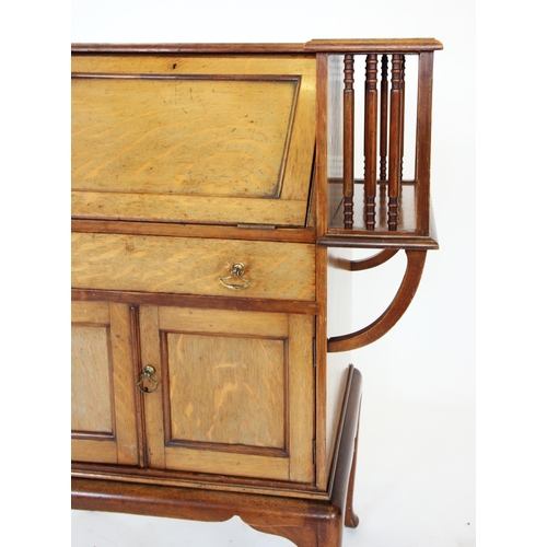 905 - An early 20th century mahogany Arts and Crafts students desk, the angular 'C' shaped top enclosing a... 