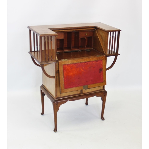 905 - An early 20th century mahogany Arts and Crafts students desk, the angular 'C' shaped top enclosing a... 