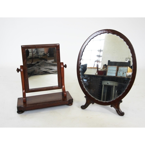 904 - An early 20th century mahogany easel dressing table mirror, the oval mirrored plate within a shaped ... 