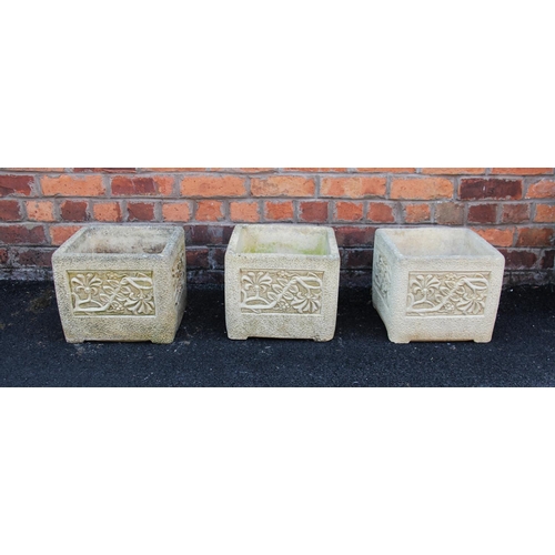 911 - A trio of 'Cotswold Studio' reconstituted stone planters, each of cubic form with foliate detail to ... 