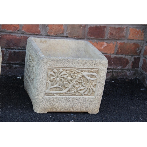 911 - A trio of 'Cotswold Studio' reconstituted stone planters, each of cubic form with foliate detail to ... 