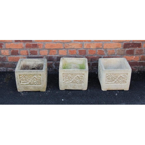 911 - A trio of 'Cotswold Studio' reconstituted stone planters, each of cubic form with foliate detail to ... 