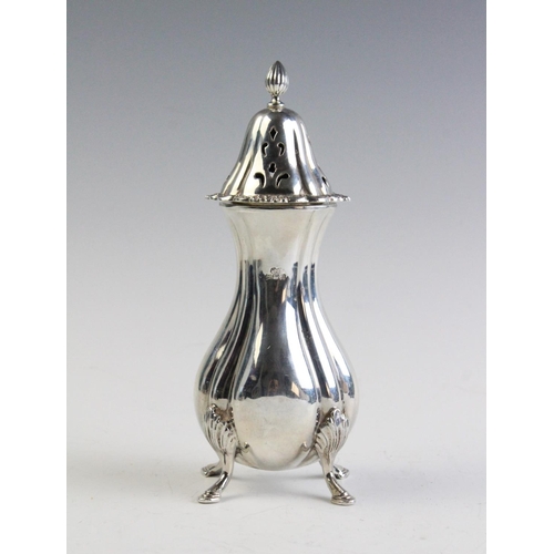 29 - A silver sugar caster by Hampton Utilities, Birmingham 1976, of baluster form on four shell-capped h... 