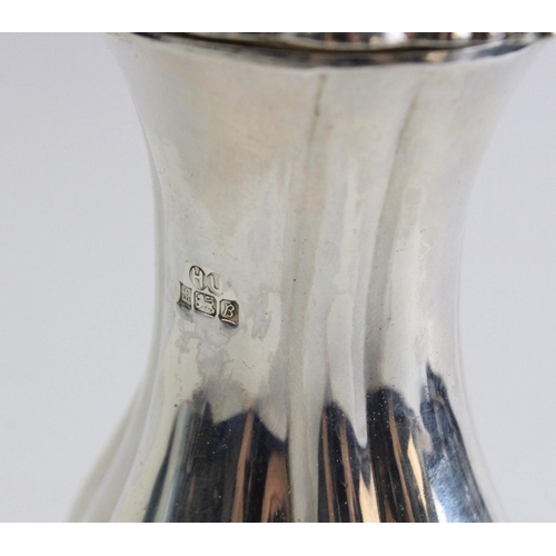 29 - A silver sugar caster by Hampton Utilities, Birmingham 1976, of baluster form on four shell-capped h... 